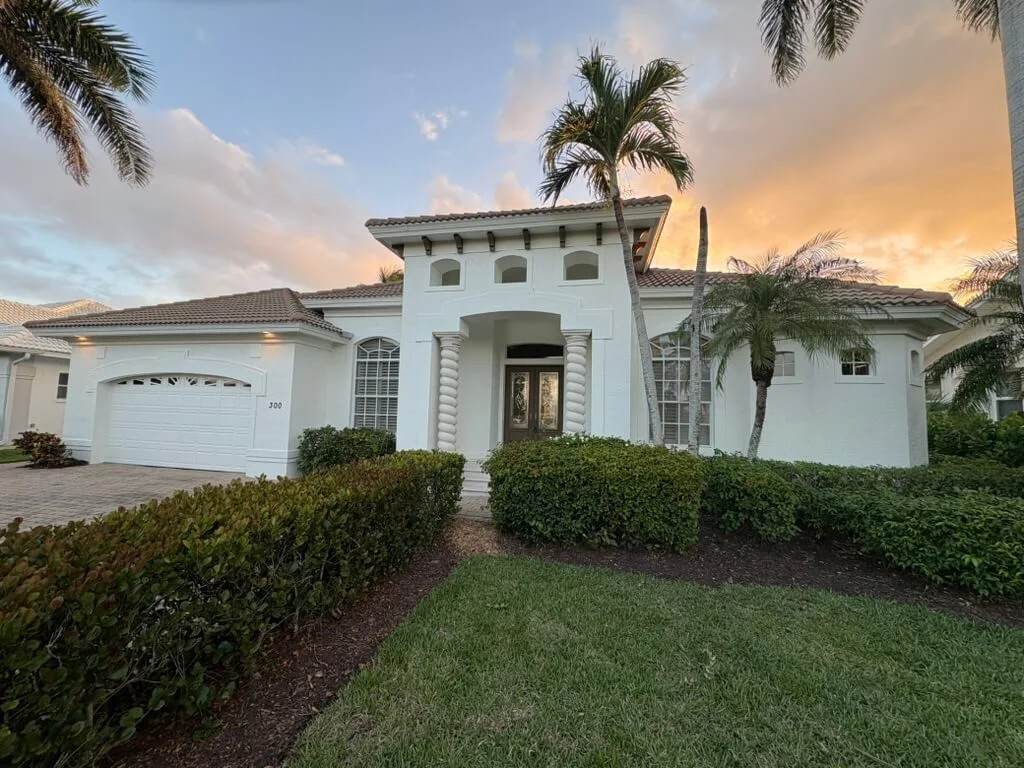 White luxury Florida home at sunset
